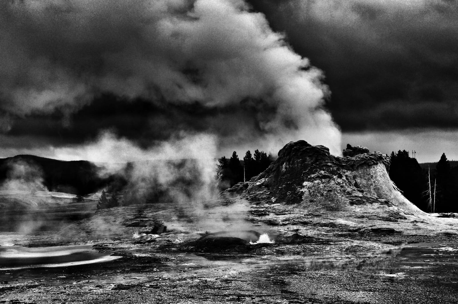 High contrast photo of steam rising from geyser vents.